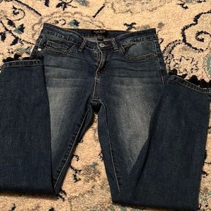 Medium wash skinny jeans with Pom Pom detail on ankle hem